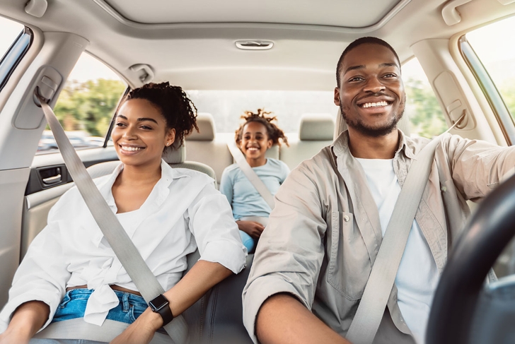Happy African American Family Riding Car Traveling By Automobile. Black Parents And Daughter Enjoying Summer Road Trip Together On Weekend. Panorama, Selective Focus